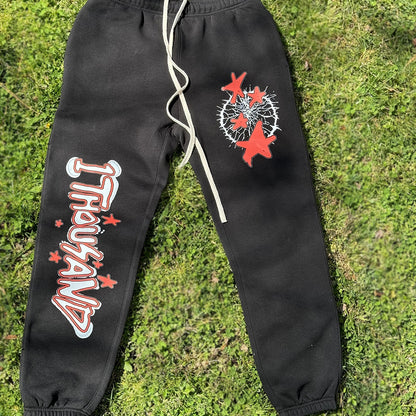 1 THOUSAND CLOTHING, HELL STAR TYPE, STREET WEAR UNISEX JOGGERS, BLACK FRONT CLOSE UP1THOUSAND CLOTHING, GRASS PHOTO,